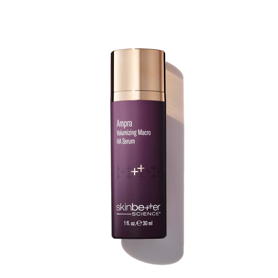 Purple skincare serum bottle with gold cap on a white background